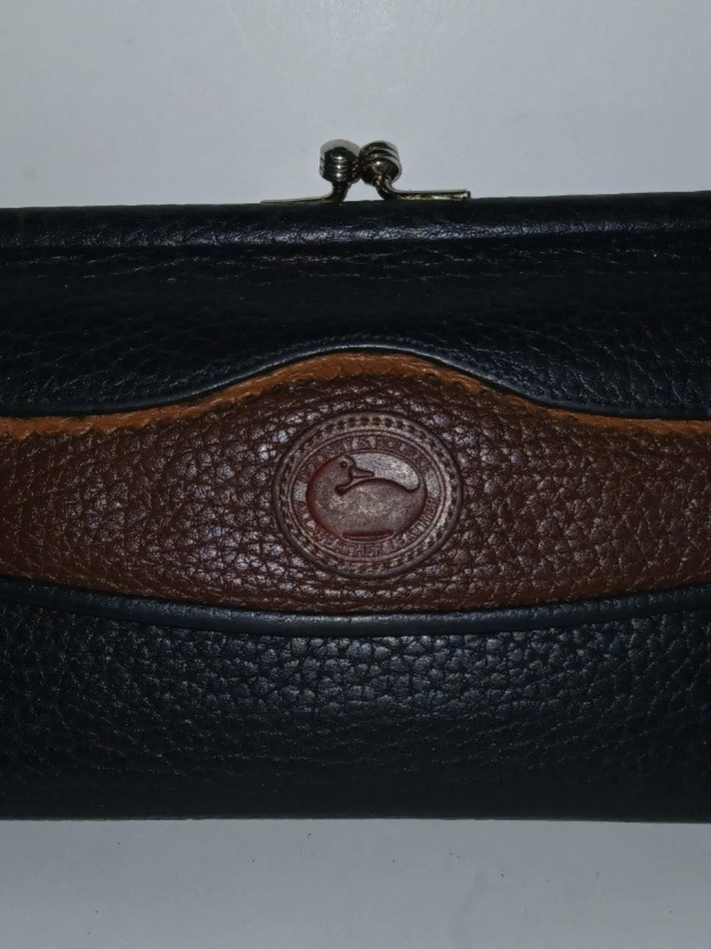 The Dooney & Bourke Black Brown Leather Kisslock Framed Credit Card Trifold